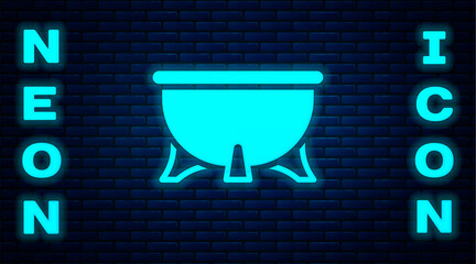 Poster - Glowing neon Halloween witch cauldron icon isolated on brick wall background. Happy Halloween party. Vector