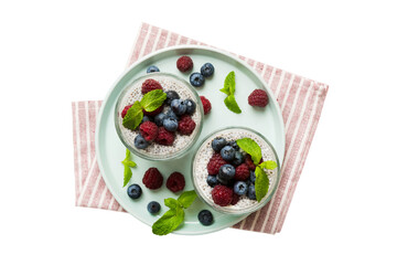 Wall Mural - Healthy breakfast or morning with chia seeds vanilla pudding raspberry and blueberry berries on table background, vegetarian food, diet and health concept. Chia pudding with raspberry and blueberry
