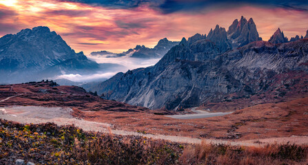 Wall Mural - Unbelievable autumn scene of Tre Cime Di Lavaredo National Park. Majestic morning view of Dolomite Alps, Auronzo Di Cadore location. Sunrise in Italy, Europe. Beauty of nature concept background.