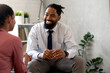 © lordn - A psychotherapist session with a patient. African-American women and men have a meeting.