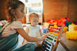 © Halfpoint - Children are playing together in indoor play area at a restaurant.