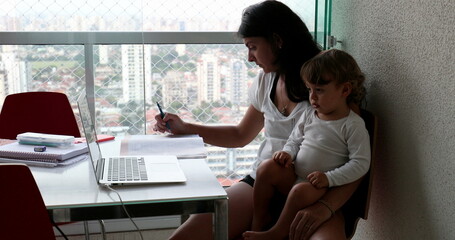 working mother holding baby toddler boy multi-tasking