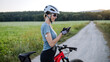 © Halfpoint - Diabetic cyclist with continuous glucose monitor checking on smartphone smartphone her blood sugar levels in real time.