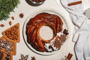 Wall Mural - Composition with tasty Christmas pastry wreath, cookies, nuts and spices on light background