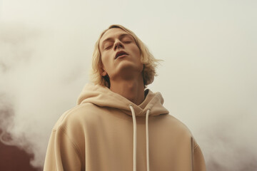 Aufkleber - A man wearing a hoodie looks up into the sky. This image can be used to depict curiosity, wonder, or contemplation. It is suitable for various themes and concepts.