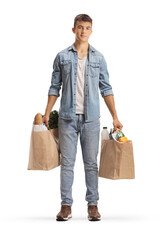 Poster - Full length portrait of a male teenager holding grocery bags