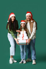 Poster - Happy family with Christmas presents on green background