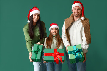 Poster - Happy family with Christmas presents on green background