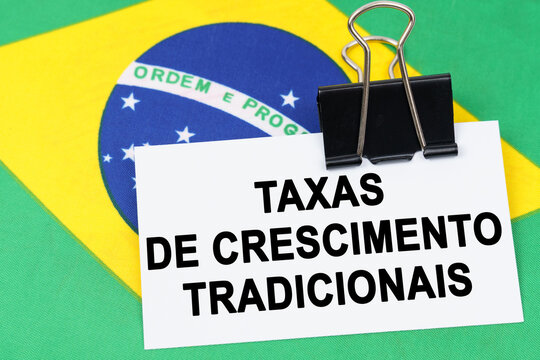 On the flag of Brazil lies a business card with the inscription - traditional growth rates