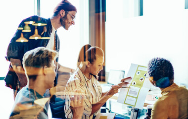 Skilled crew of male and female colleagues having brainstorming session discussing strategy for startup