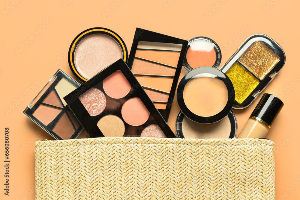 Wicker bag with different decorative cosmetics on orange background