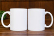 © Gravity Digital - 2 White 11 oz white mug on a green wooden background  . 11oz cups mock up for your front - back design