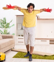 Wall Mural - Young handsome man doing housework