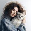 Young sensual curly woman hugs, holds white long-haired cat in her arms