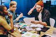 © BullRun - Skilled trendy dressed hipsters cooperating and learning together share ideas