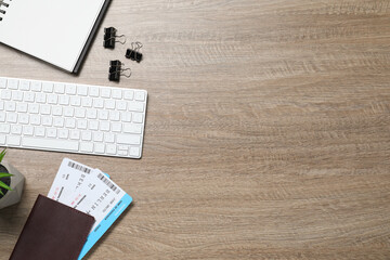 Canvas Print - Flat lay composition with tickets, passport and keyboard on wooden table, space for text. Business trip