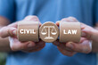 Hands holding wooden cylinders sees inscription: CIVIL LAW. Jurisprudence legal education concept. Civil rights protection.