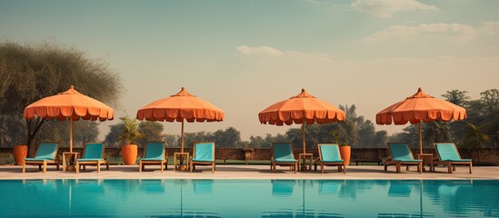 Sticker - Indian resort with umbrella chairs by the swimming pool