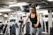 © Dusan Petkovic - A strong woman is pushing weights in a gym during her training.