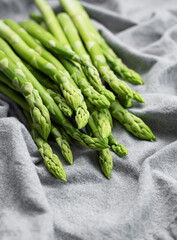 Wall Mural - Fresh green asparagus on  textile background.