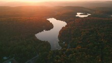 Circular Drone Shot Over Typical Canadian Landscape With Forest And Lakes During Fall Season In Quebec Province At Sunset, Canada