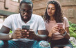 © BullRun - interested woman checking smartphone chat of husband