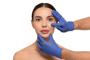 Wall Mural - Doctor checking patient's face before cosmetic surgery operation on white background