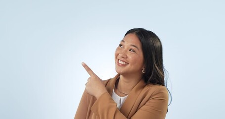 Canvas Print - Business woman, point and smile in studio, face and space for choice, vote or review by blue background. Asian entrepreneur, happy and hand sign for decision, feedback or sale with mockup in portrait