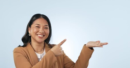 Poster - Smile, pointing and face of woman in a studio with mockup for advertising, promotion or marketing. Happy, excited and portrait of young Asian female model with show hand gesture by white background.