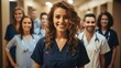 © visoot - Smiling woman doctor standing with medical colleagues in a hospital corridor.