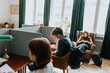 © Maskot - Teenage boy sitting near female students in library