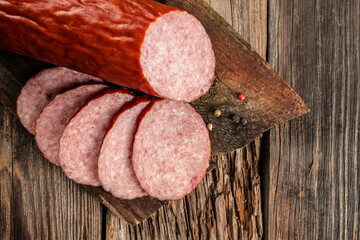 Wall Mural - Salami sausage slices on a wooden board. banner, menu, recipe place for text, top view