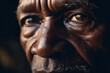 Extreme close up of black African man face with intense macro eyes and stare, face of stories wrinkles and adventures