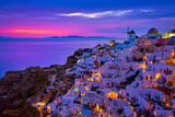 Fototapeta Uliczki - Oia village, windmills, Santorini island, Greece at colorful sunset