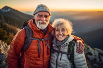 Wall Mural - Old hiking couple with grey hear enjoy the beautiful sunset in the mountain during a hiking tour and making a happy smiling self portrait selfie, generative ai 