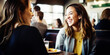 © Jasmina - Happy smiling female friends sitting in a café laughing and talking during a lunch break