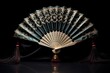 a single oriental hand fan opened on a black velvet surface