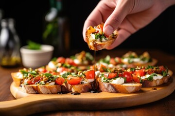 Canvas Print - a hand serving a platter of bruschetta with mozzarella slices