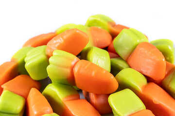 Sticker - jelly carrots candies on a white background. Colorful fruit gum candies.