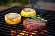 filet mignon, rosemary sprigs, and lemon on grill