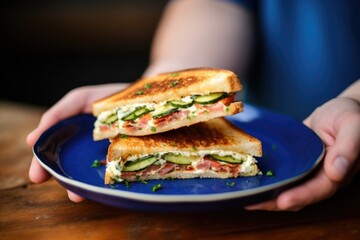 Poster - hand serving brick-pressed grilled sandwich on plate