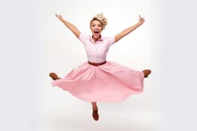 Full Length Portrait Of A Happy Young Woman Jumping Isolated On A White Background