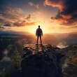 © mirexon - Young man standing on top of a cliff in the summer mountains at sunset and enjoying the view of nature