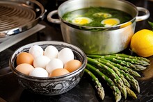 Asparagus In Half While Boiled Quail Eggs Sit In A Pot
