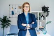 © okrasiuk - Portrait of smiling 50's stylish, confident mature businesswoman, middle aged company ceo director, experienced senior female professional, business coach team leader in modern office. Female leader.