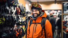 Man picks out ski equipment for the mountains at the store