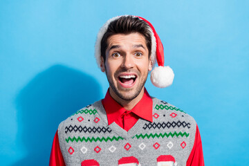 Poster - Photo portrait of nice young male look camera excited impressed dressed x-mas print vest hat garment isolated on blue color background