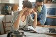 © Geber86 - Stressed young couple doing financials in the kitchen