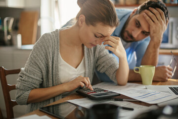 Wall Mural - Stressed young couple doing financials in the kitchen