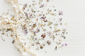 Background of dry delicate flowers and pearls